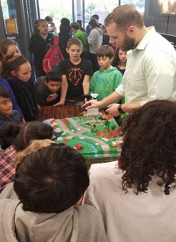 Framingham Conservation staff use the Enviroscape model to teach elementary students about watersheds during MassSTEM Week 